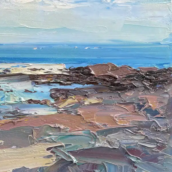 Detailed macro view of the right section, showcasing the rich textural contrast of the dark sandy shore and turquoise water.