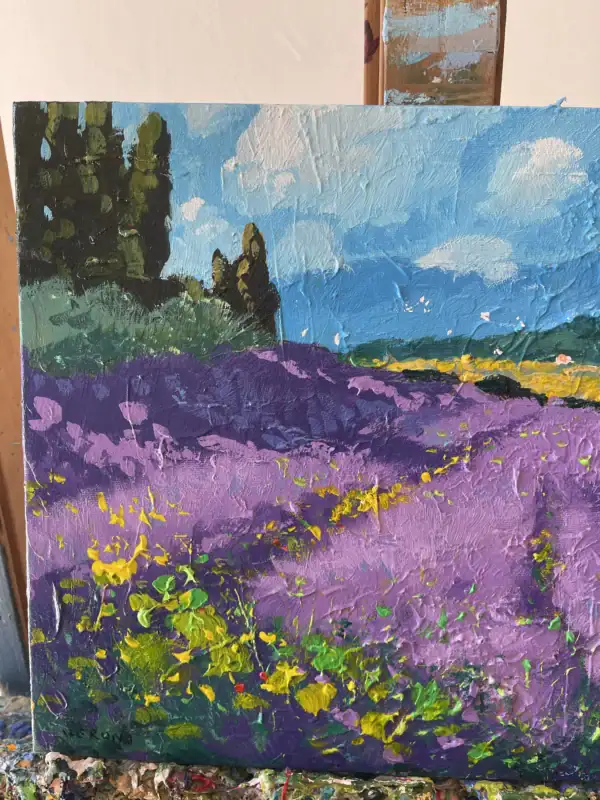 Close-up vertical macro view on the easel focusing on the intense purple palette knife strokes and yellow wildflowers on the left side.