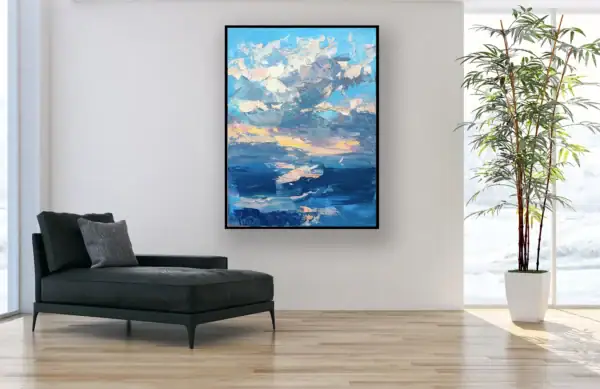 The vertical original ocean sunset oil painting displayed as an elegant focal point in a bright minimalist lounge beside a modern black chaise longue.