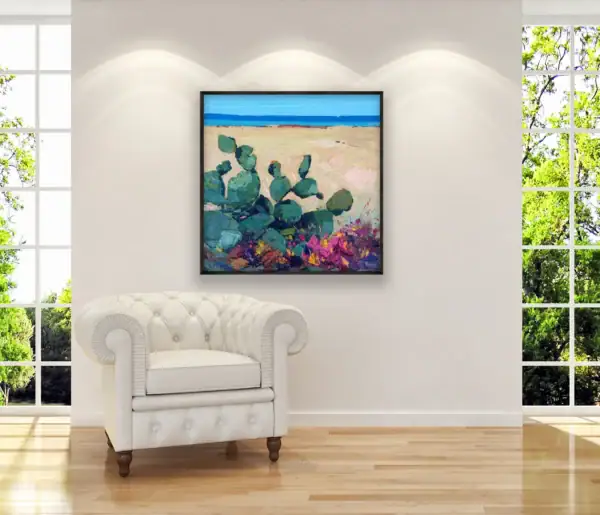 Modern impressionist seascape oil painting displayed on a living room wall above a white armchair.