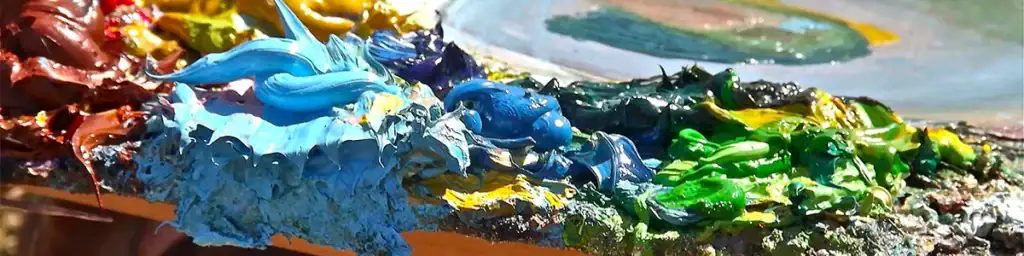 Close-up of thick, textured oil paint on the palette for online custom oil painting services for home decor by artist Agostino Veroni.