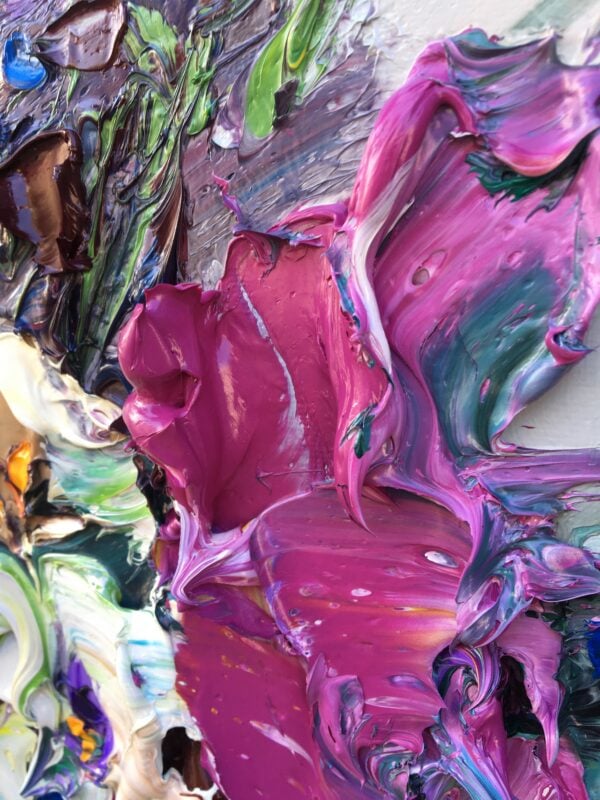 Extreme close up of thick magenta palette knife impasto texture in original floral oil painting