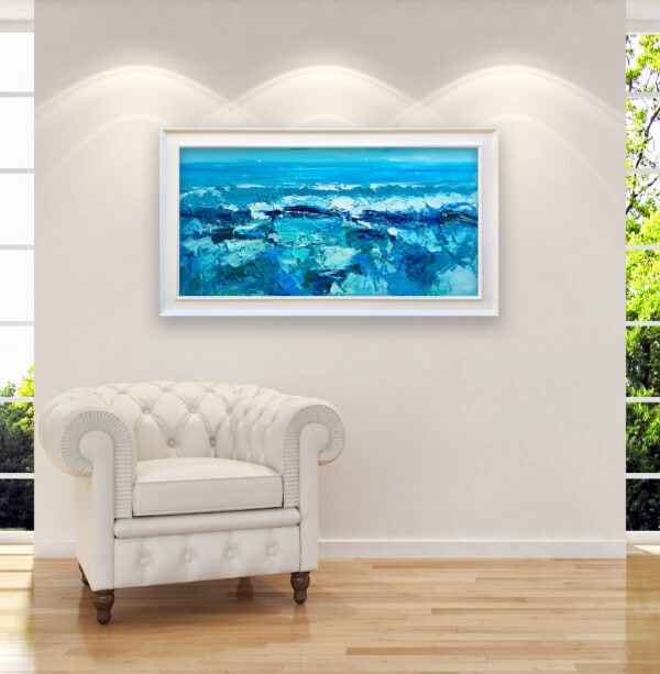 An original ocean waves oil painting by Agostino Veroni framed and hanging on a wall next to an elegant white leather armchair.