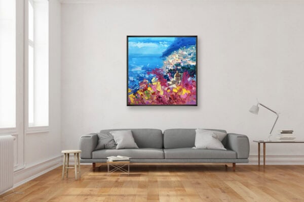 Original Positano oil painting displayed above a modern grey sofa in a bright living room setup.