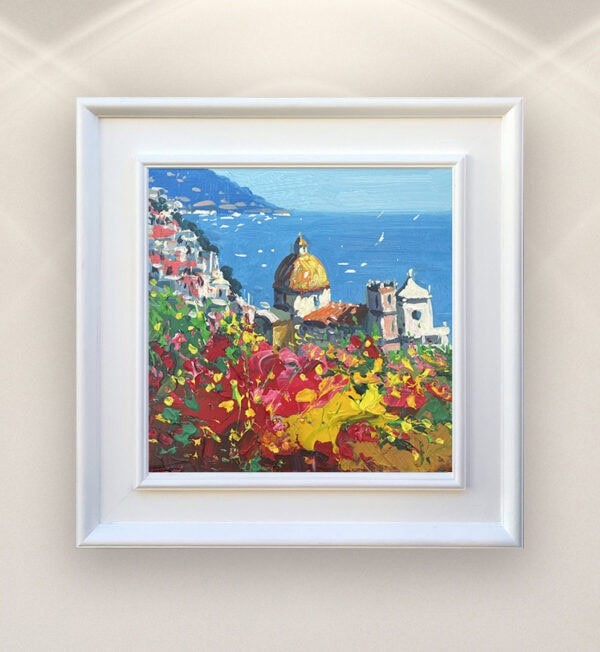 A framed Positano oil painting by Agostino Veroni on a living room wall in a modern interior setting.