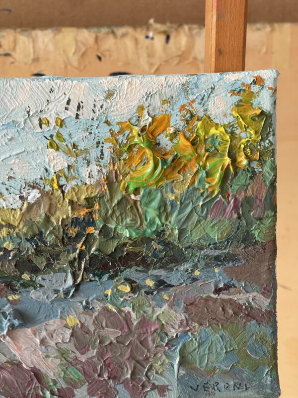 Summer beach oil painting on canvas detail on easel focusing on yellow coastal vegetation. Thick palette knife impasto texture depicting green dunes and sky on the right side.