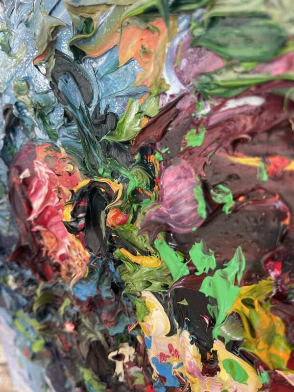 Pomegranate oil painting on canvas detail highlighting rich impasto technique. Sculptural palette knife strokes blending deep crimson, vibrant green, yellow, and violet tones.