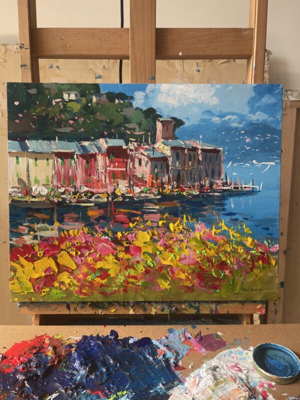 Original Portofino oil painting on an artist easel in the studio with palette and paints by Agostino Veroni.